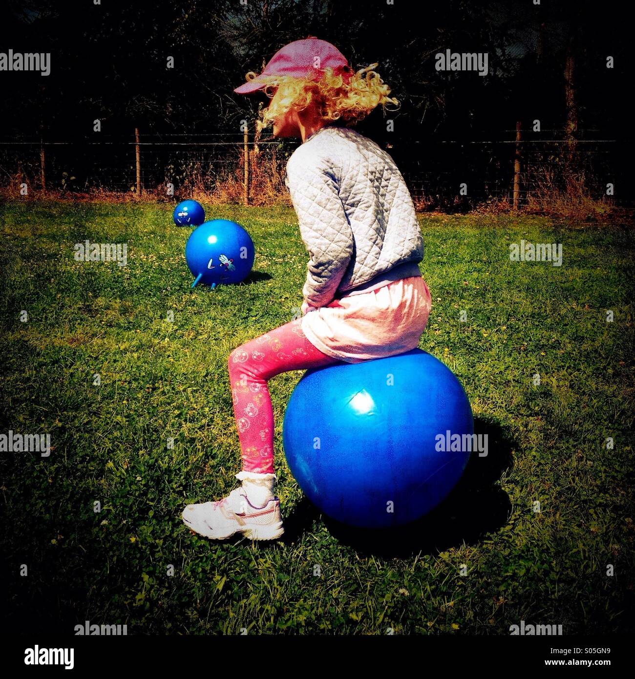 Young girl bouncing on space hopper Stock Photo