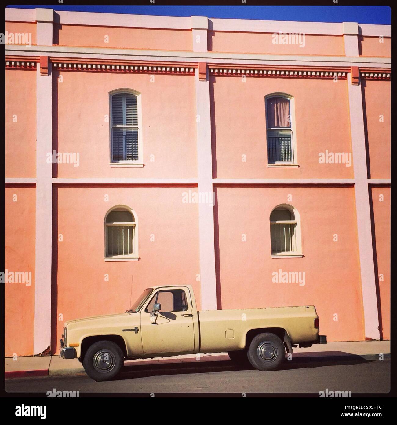 Yellow truck peach wall - Smartphone Captured Stock Image