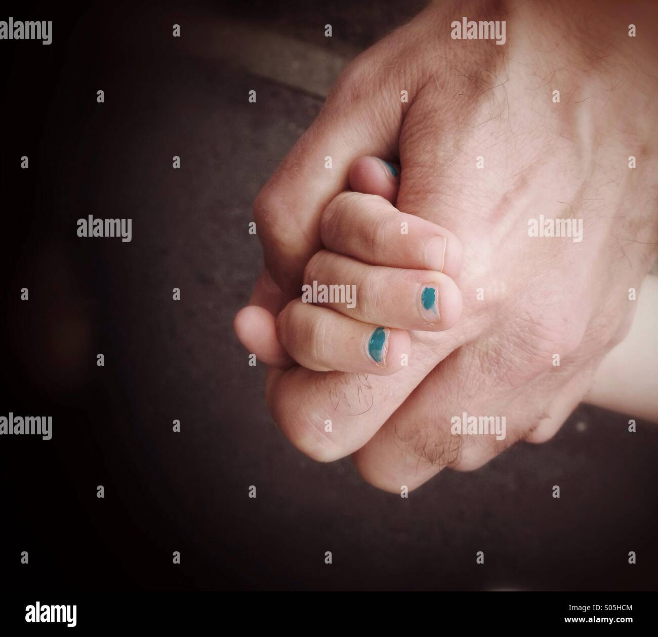 Close up of adult and child holding hands Stock Photo