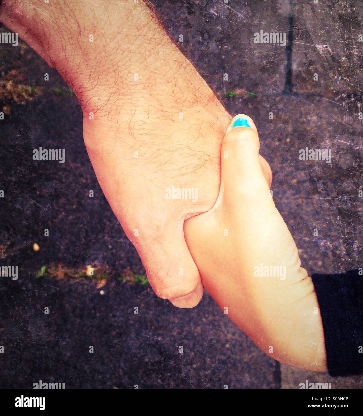 Close up of adult and child holding hands Stock Photo - Alamy