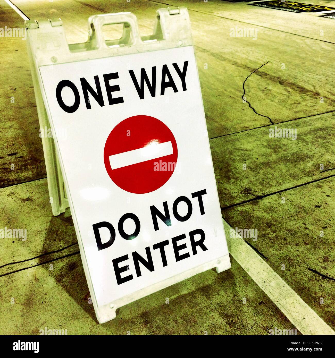 Portable One Way sign in a parking lot. - Smartphone Captured Stock Image