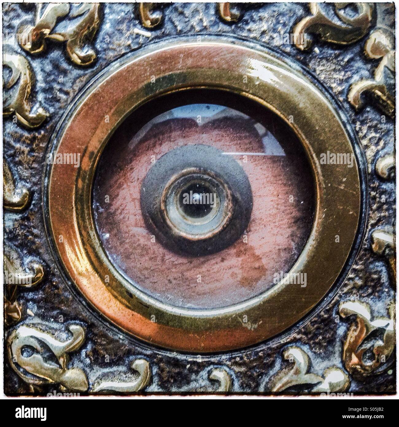 Eye peephole on door seen from the outside. Small hole covered with glass Stock Photo