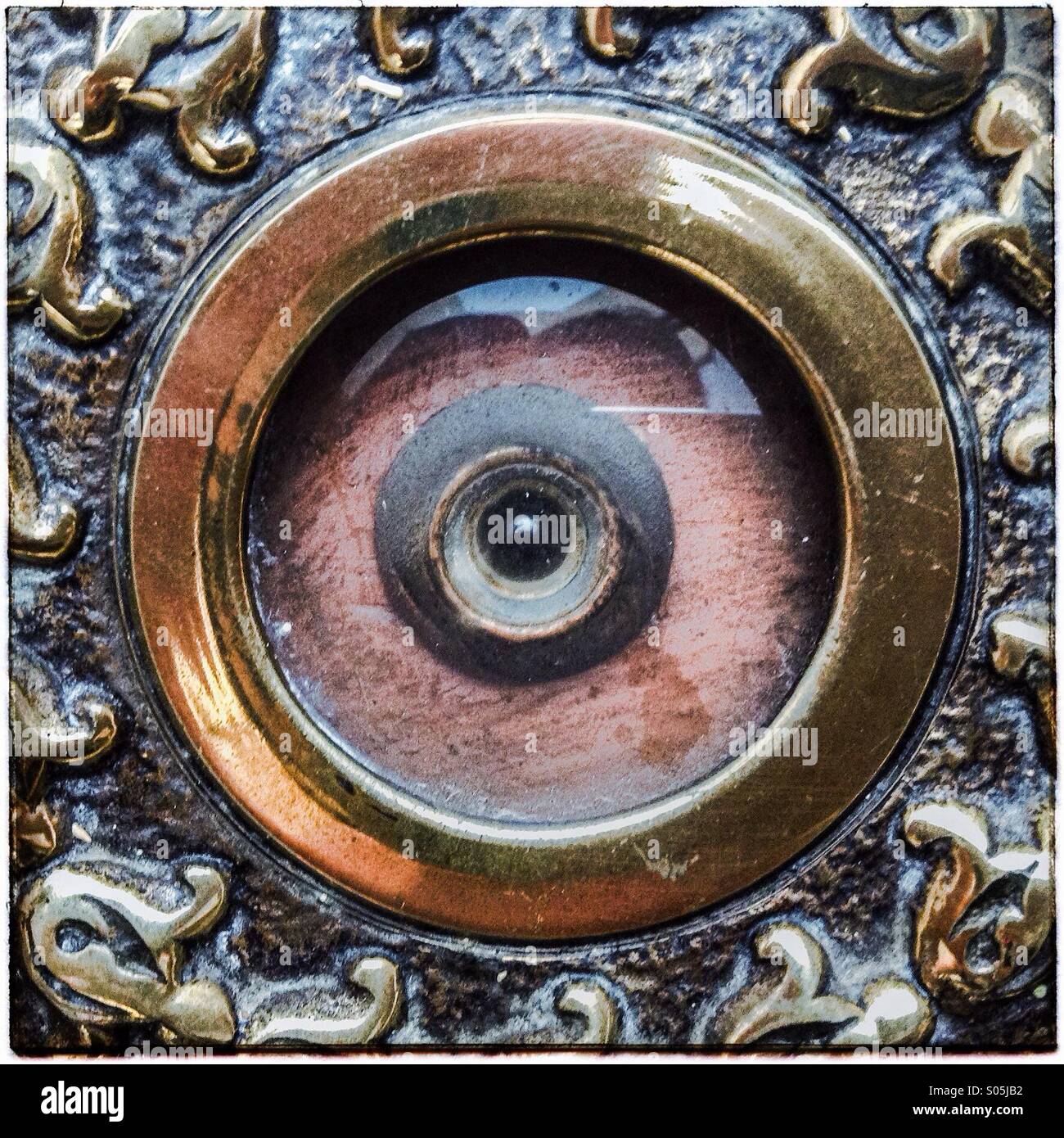 Eye peephole on door seen from the outside. Small hole covered with