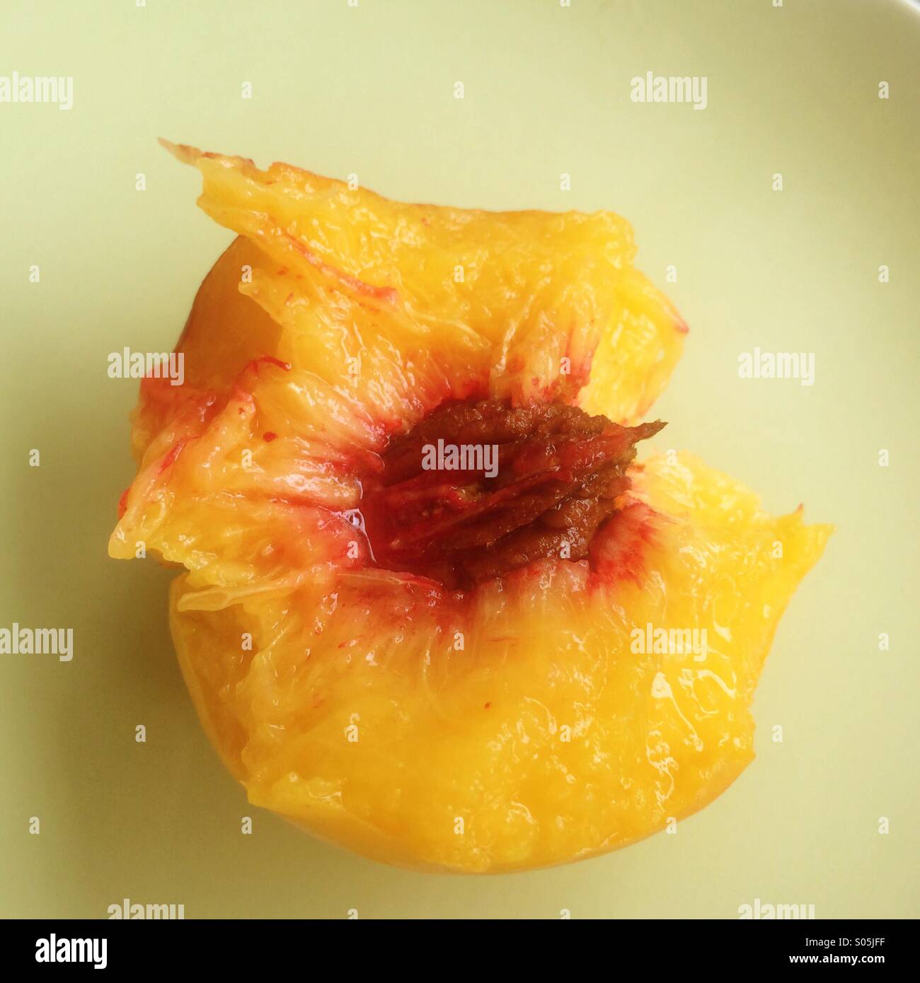 Half eaten fresh Georgia peach. Stock Photo