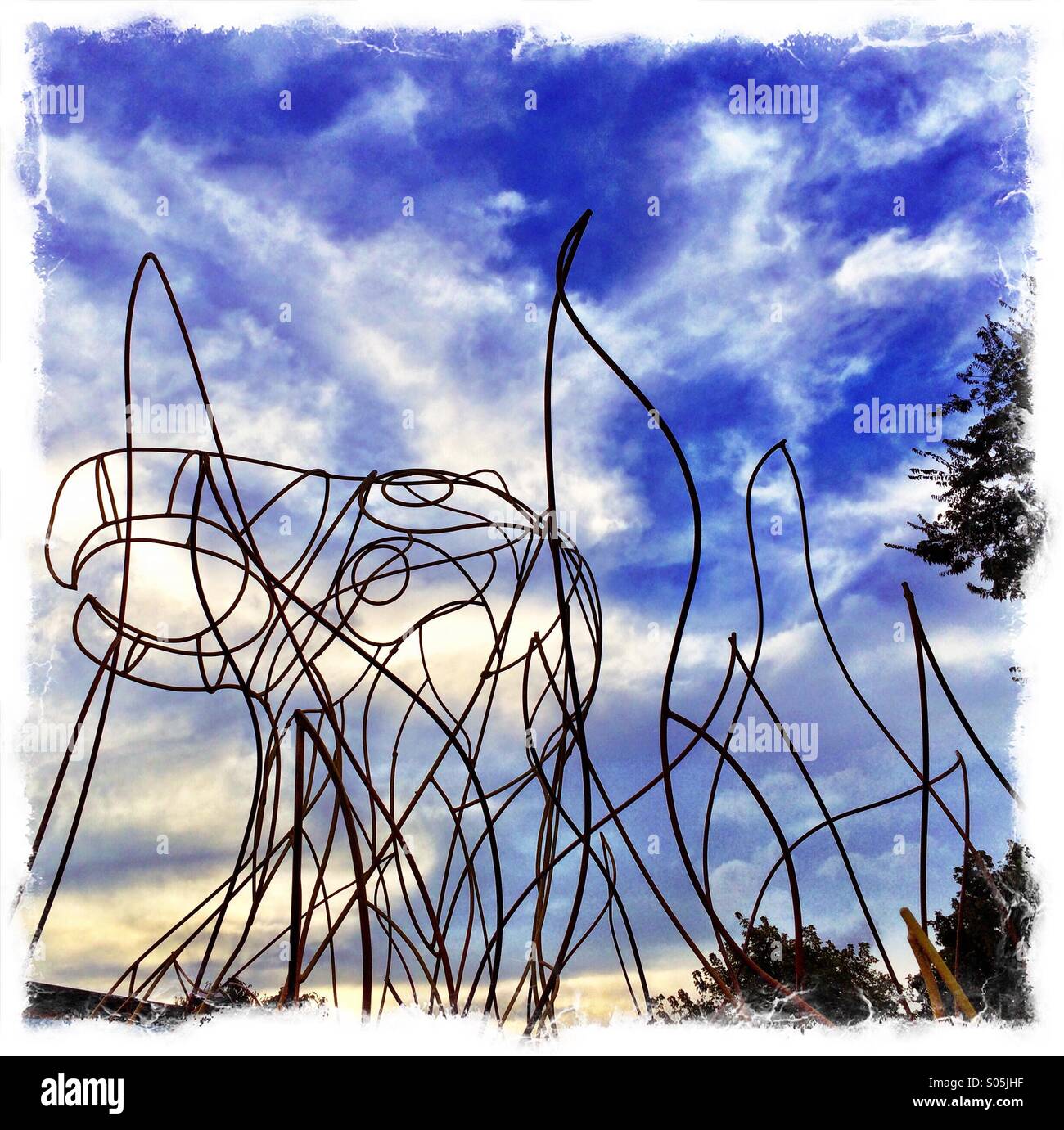 A sculpture of a Phoenix with flames on the Atlanta Beltline, a cycling and walking path built on an old railway corridor around the city. - Smartphone Captured Stock Image
