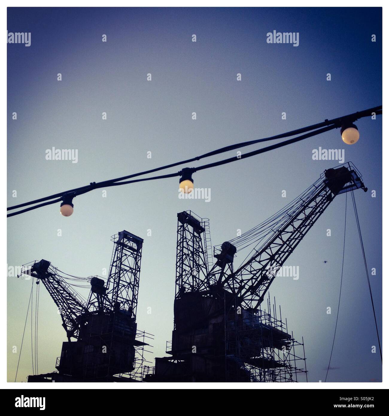 Cranes and lightbulbs Stock Photo