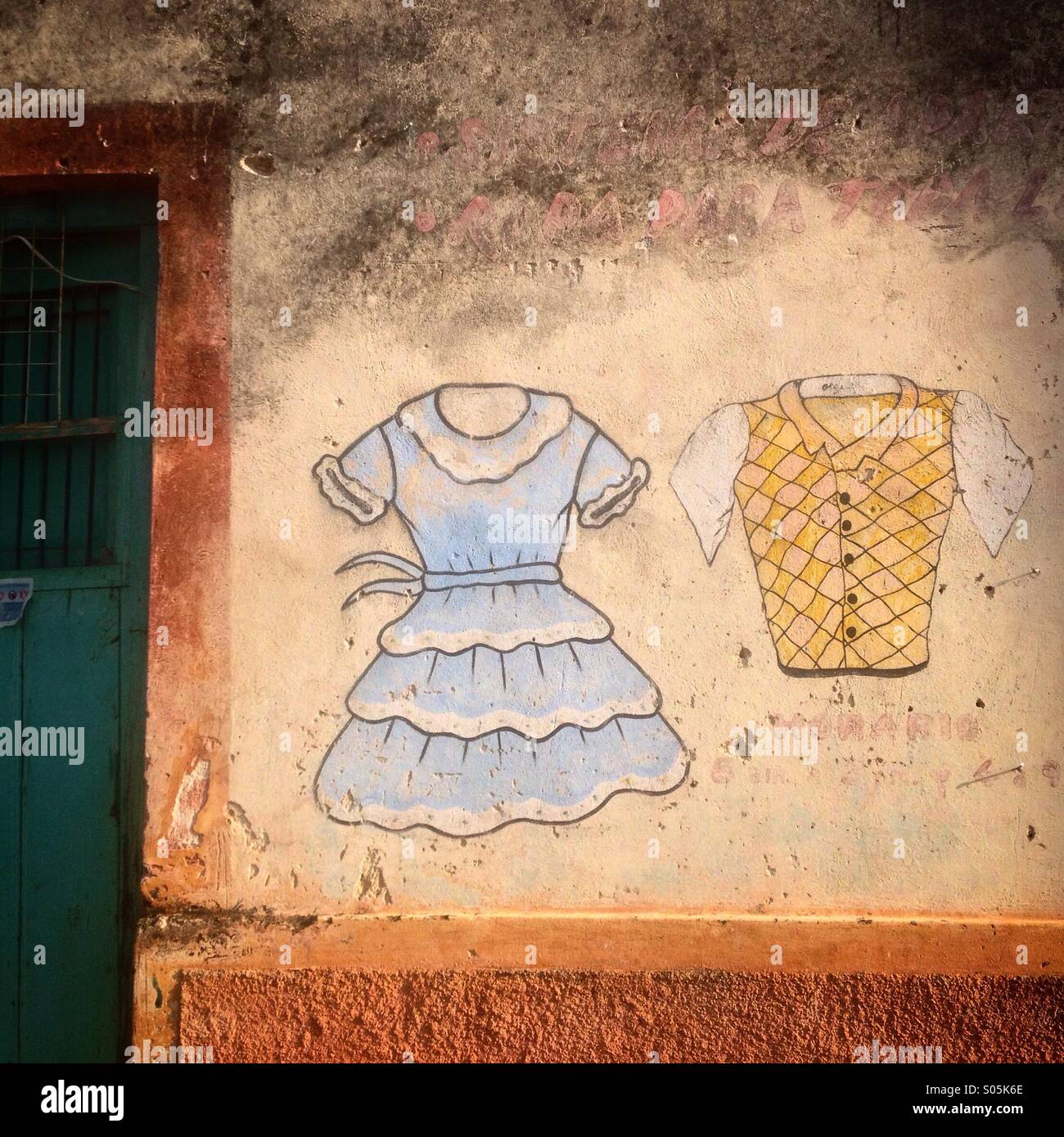 A painting of a dress and a shirt decorates a clothing shop in Santa Elena, Yucatan, Mexico - Smartphone Captured Stock Image