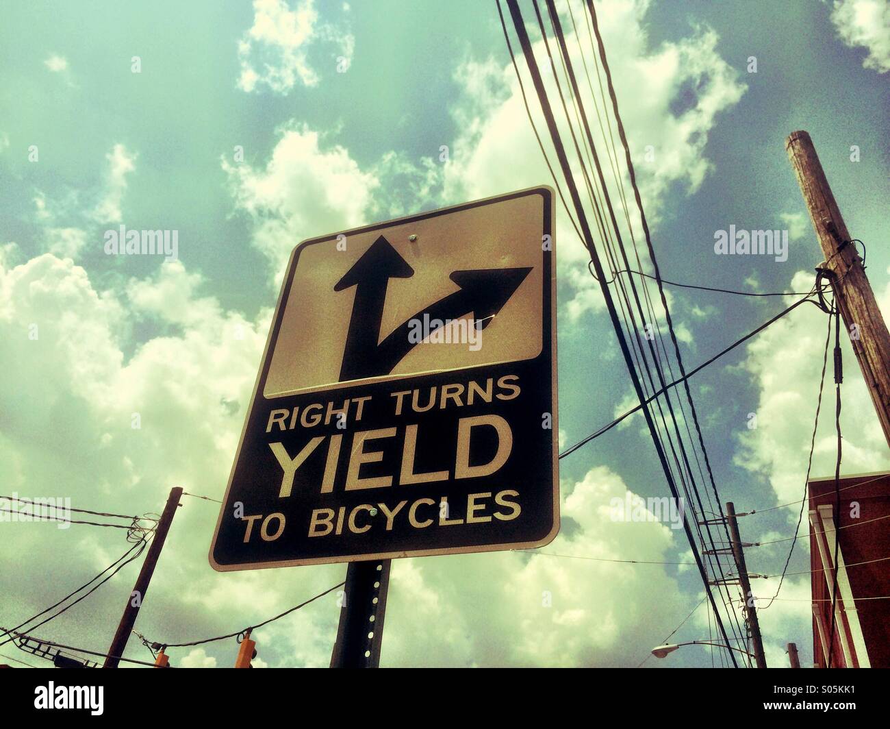 Right Turns Yield To Bicycles road sign. Stock Photo