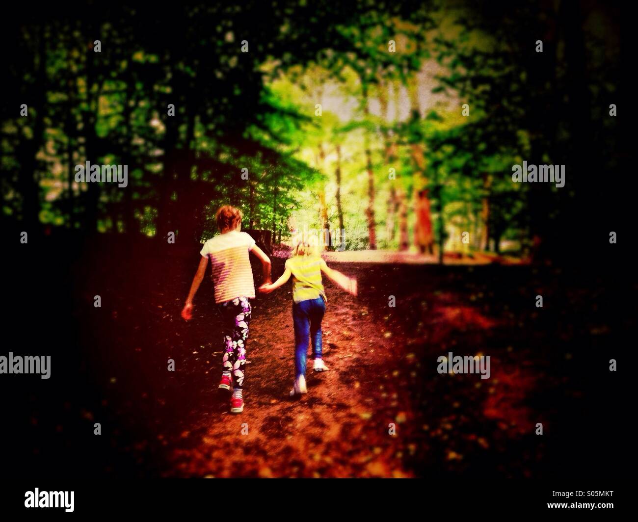 Two girls holding hands hi-res stock photography and images - Alamy
