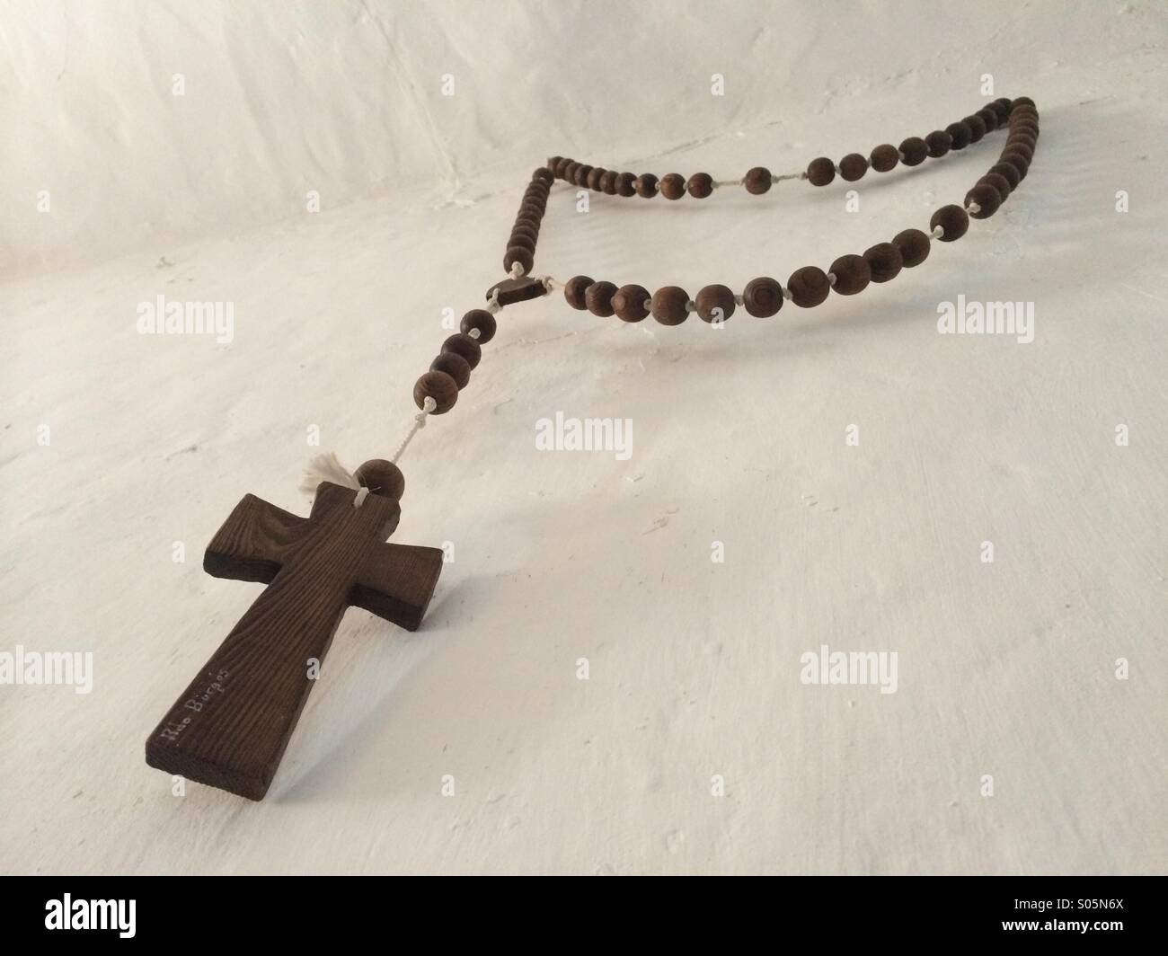 Christian cross hung from white wall, Spain Stock Photo Alamy