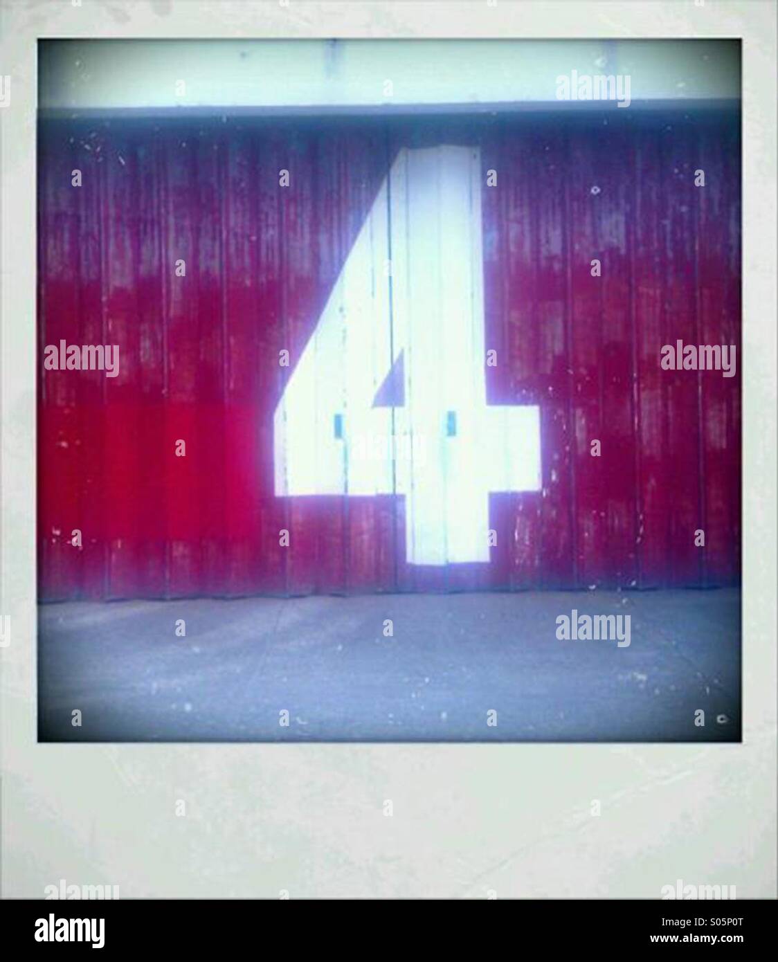 Number 4 painted on a warehouse door - Smartphone Captured Stock Image