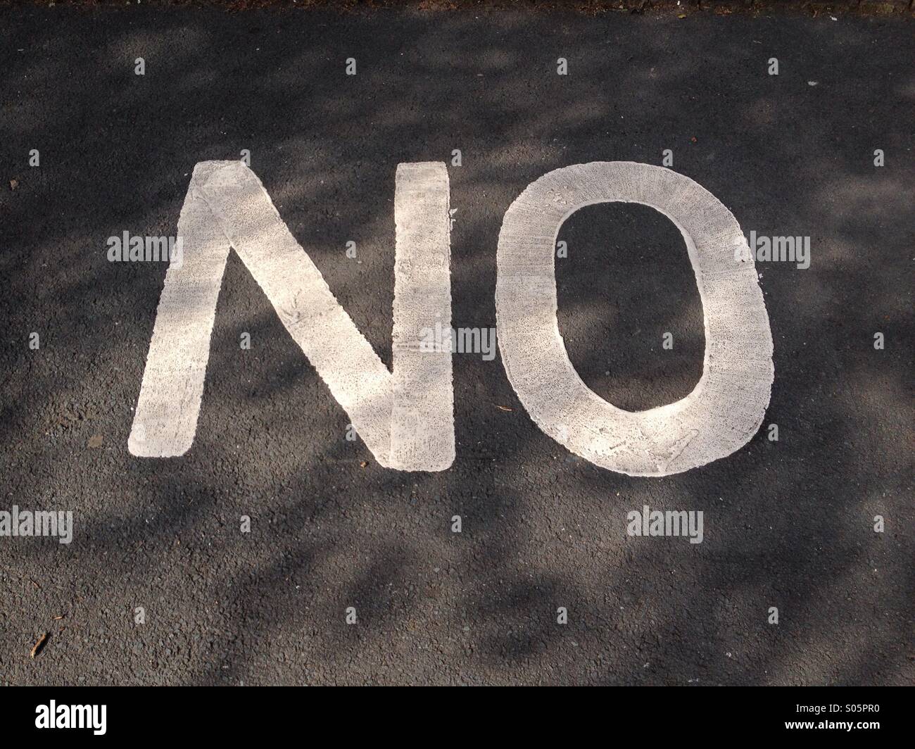 Close up of the word 'NO' on pavement - Smartphone Captured Stock Image