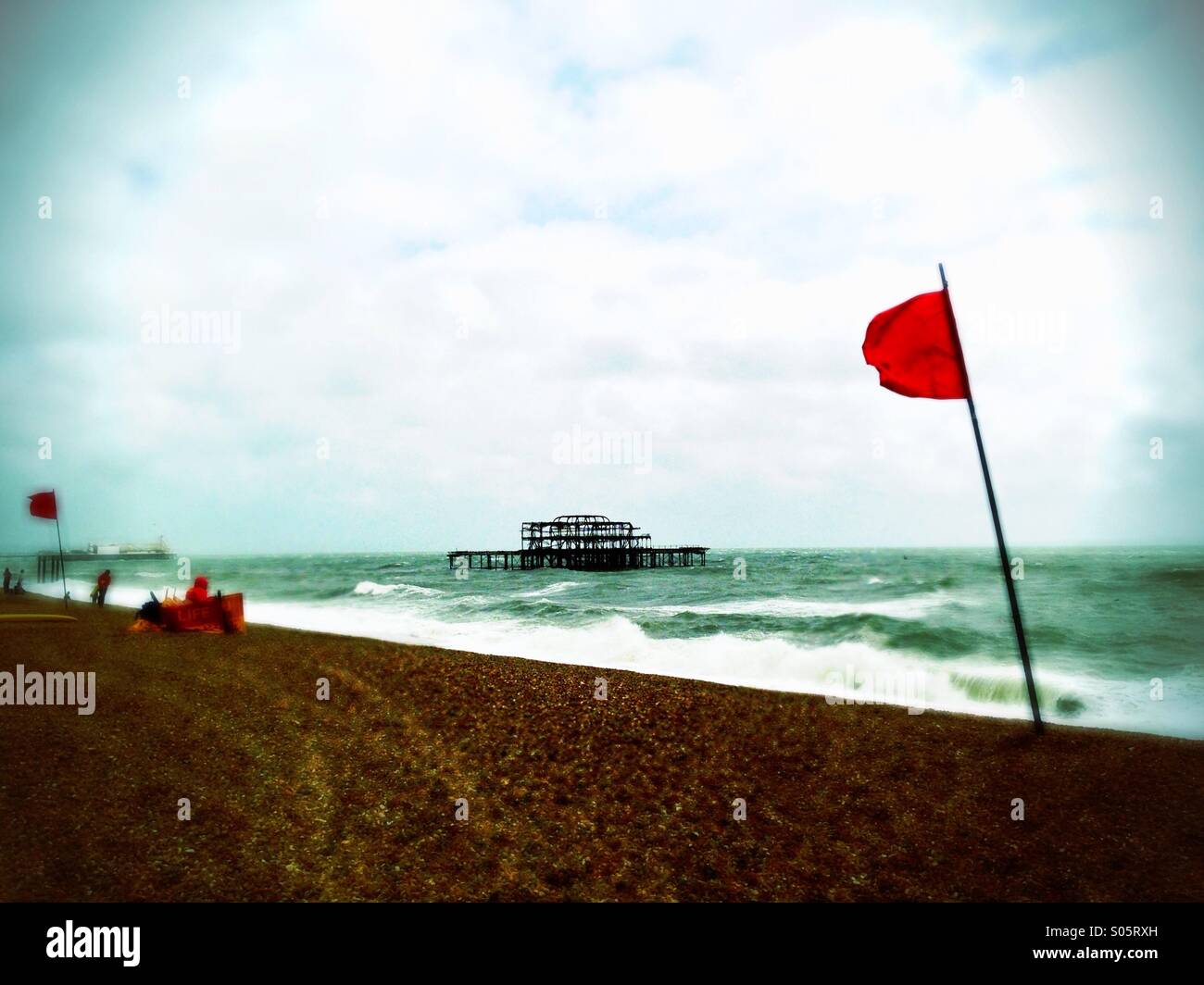 Red flag by West Pier on Brighton Beach. Stock Photo