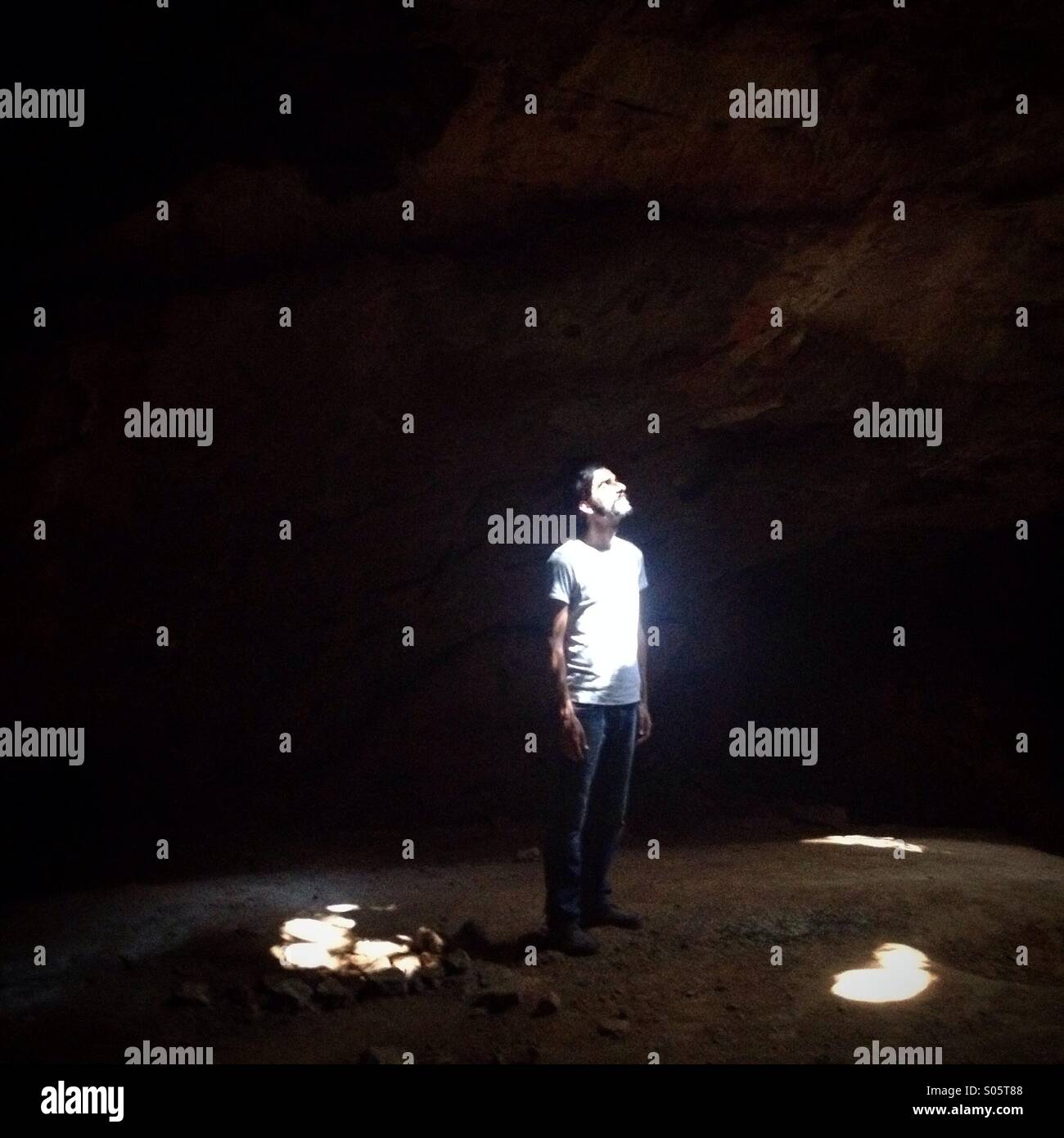 A man stands in Usil cave, near Oxkintok in Maxcanu, Yucatan, Mexico - Smartphone Captured Stock Image