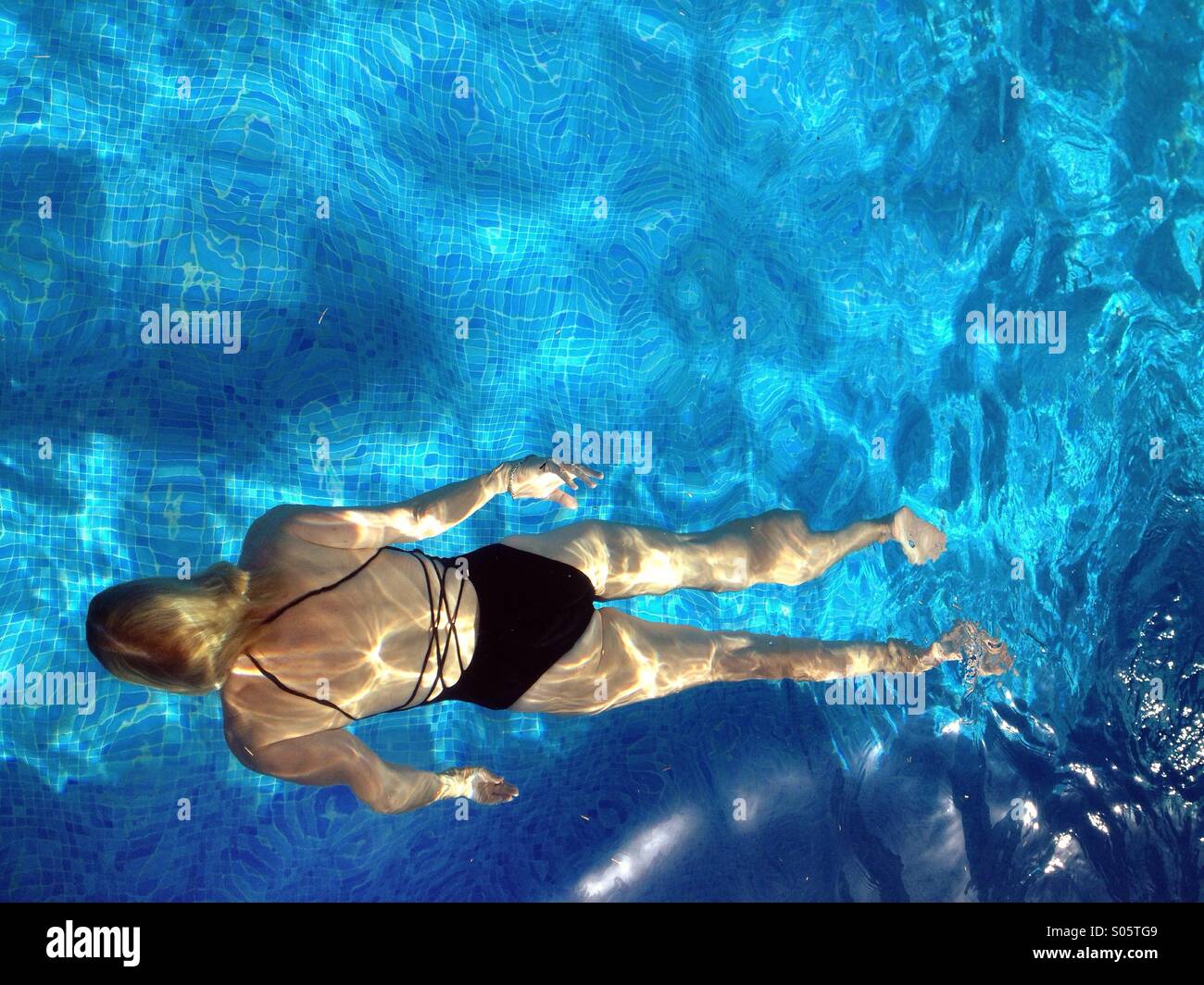 Woman swimming in pool Stock Photo