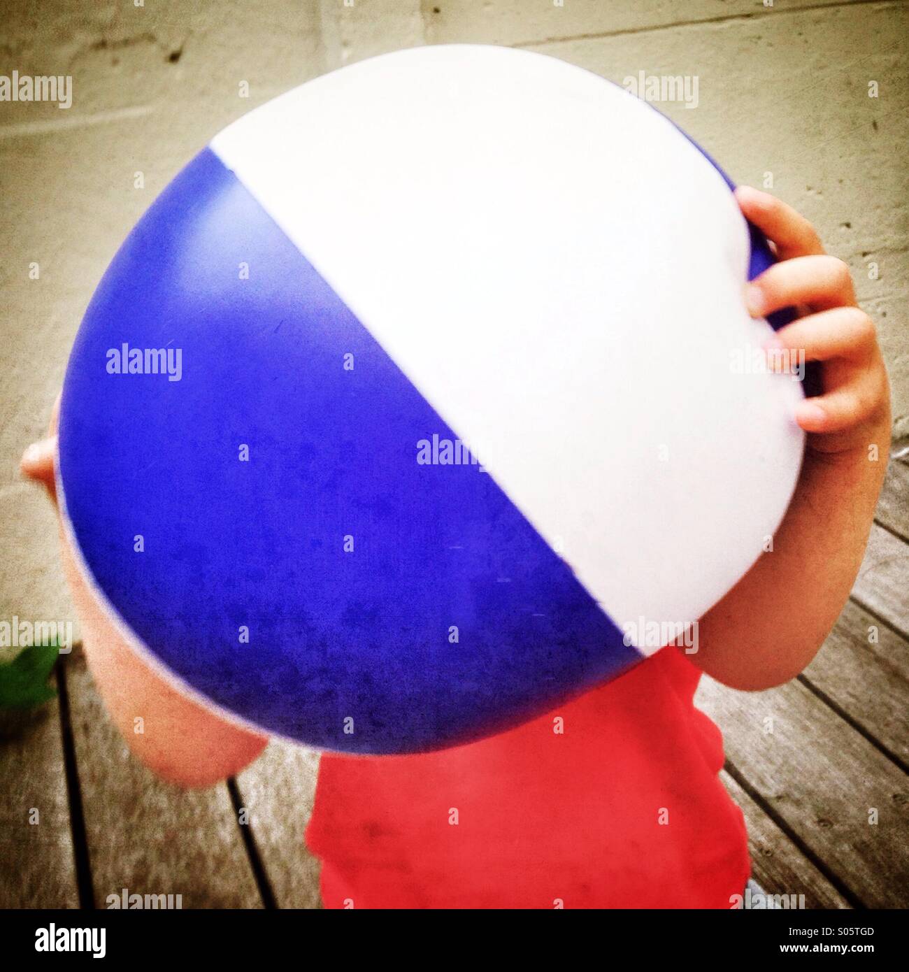 Kid holding beach ball Stock Photo