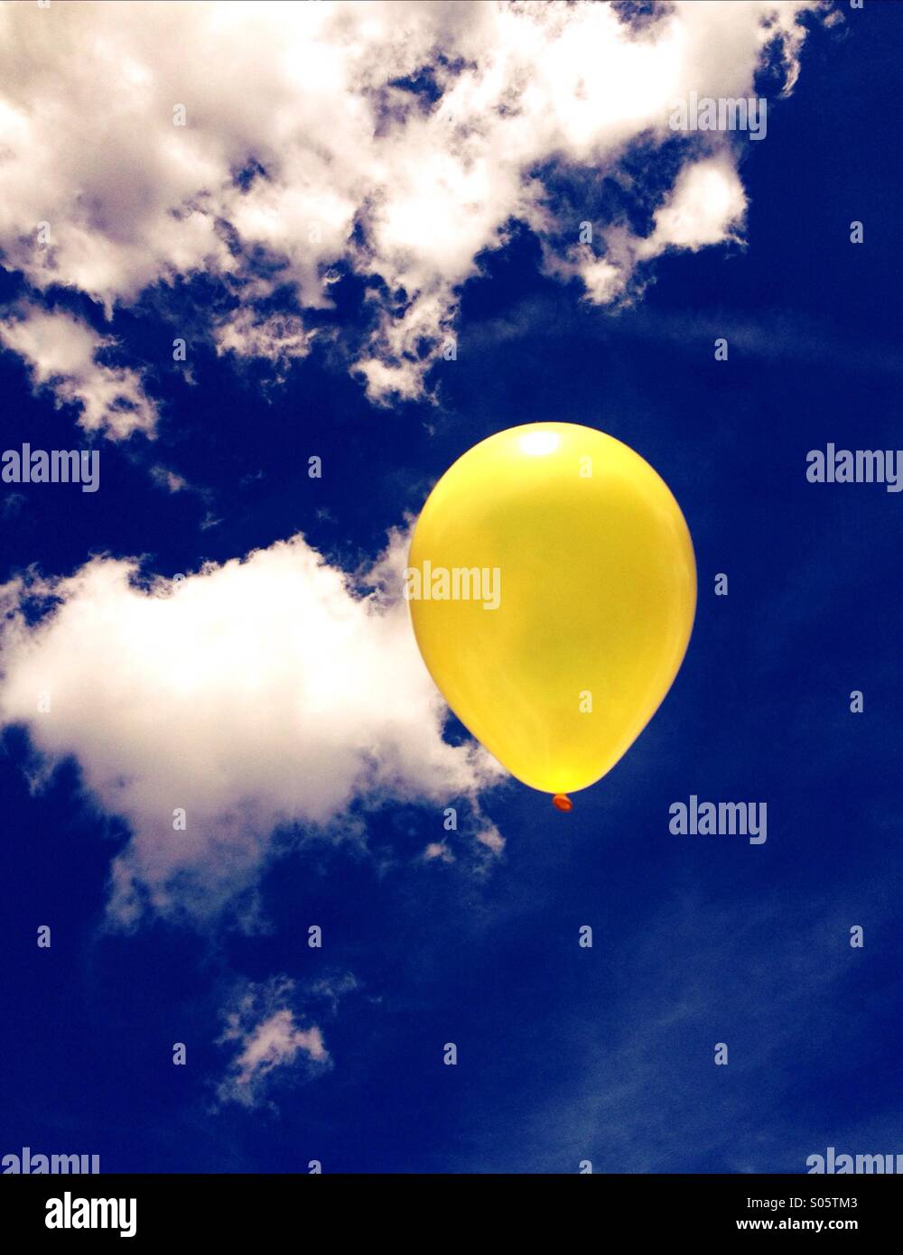 Yellow balloon against a summer sky - Smartphone Captured Stock Image