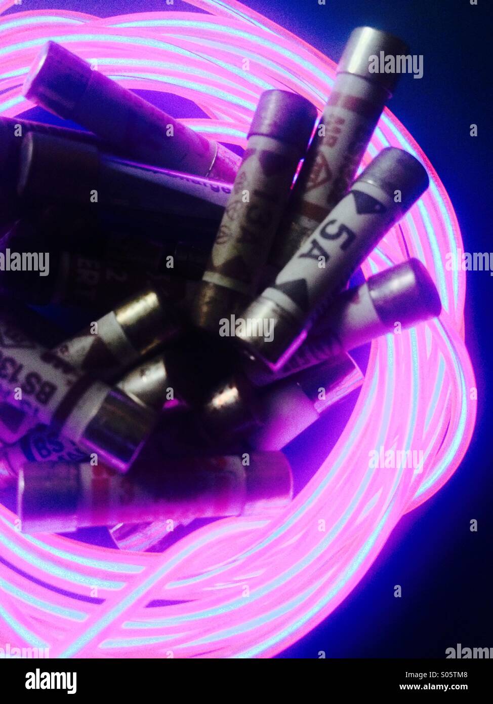 Household fuses surrounded by glowing wire - Stock Image