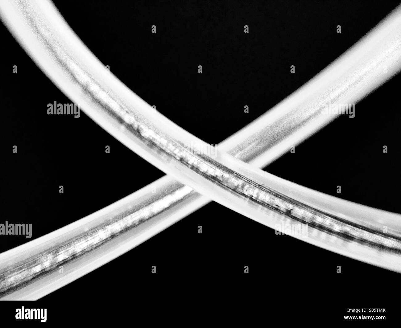 Monochrome view of glowing wire in the shape of a cross - Smartphone Captured Stock Image