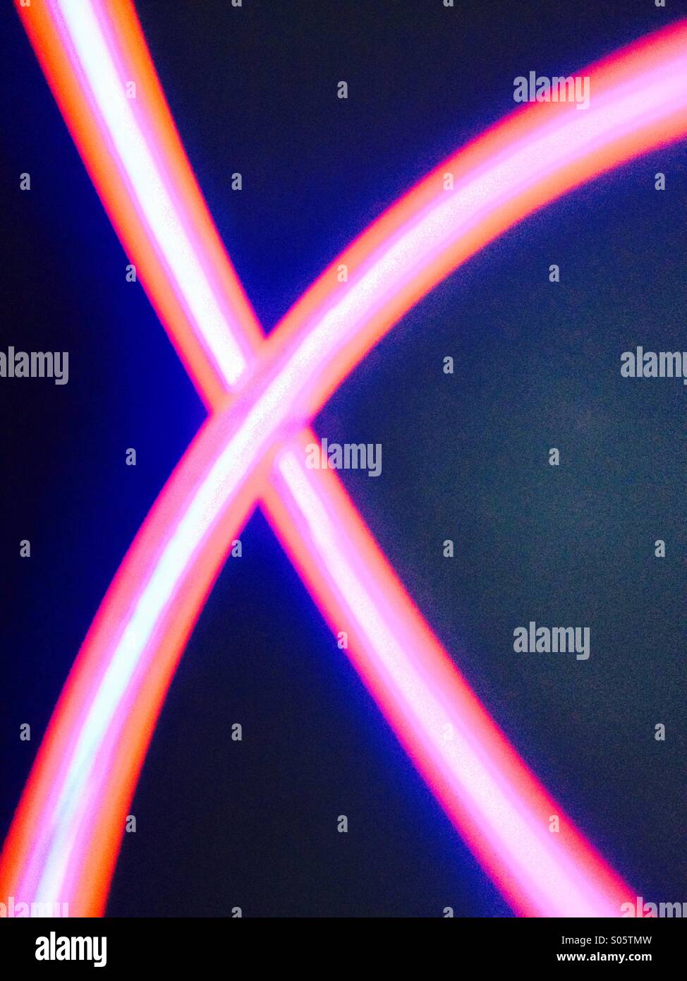 Pink glowing wire in the shape of a cross - Smartphone Captured Stock Image