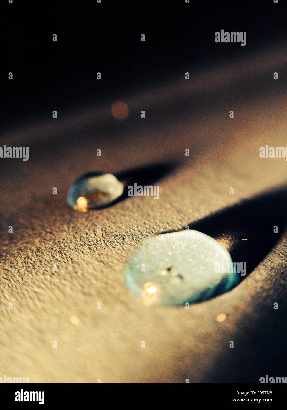 Water drops lit by a torch - Smartphone Captured Stock Image