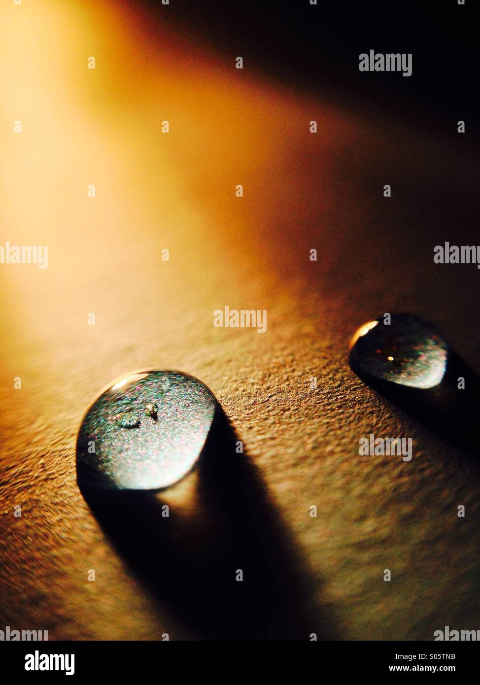 Water drops lit by a torch - Smartphone Captured Stock Image