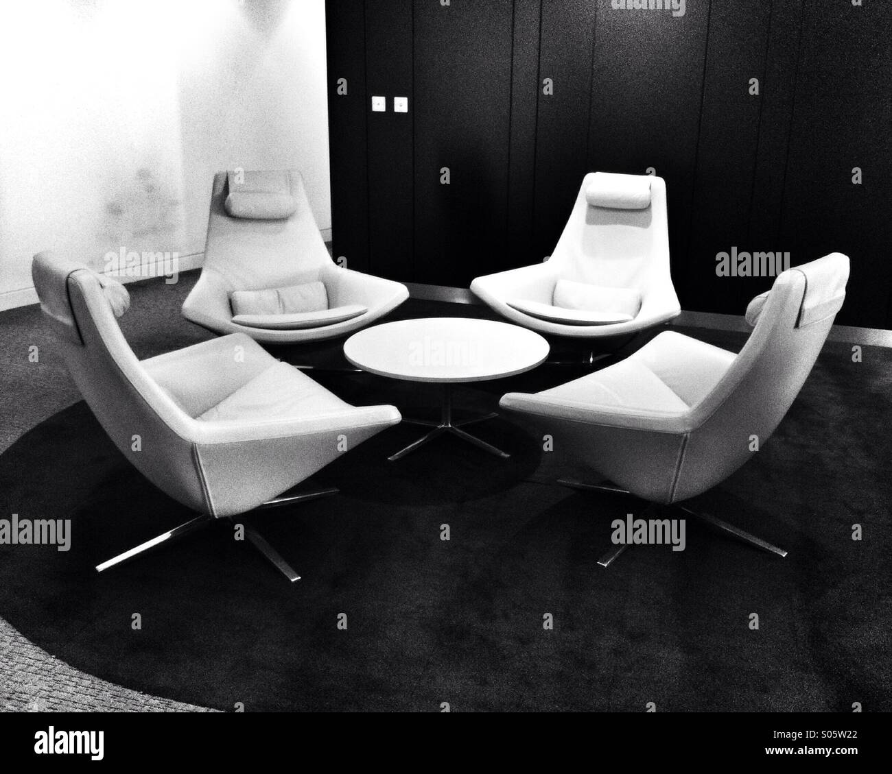 Four meeting room chairs around a coffee table - Smartphone Captured Stock Image