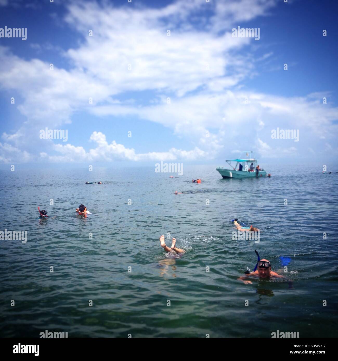Tourists swim and snorkel in Holbox island, Quintana Roo, Yucatan peninsula, Mexico - Smartphone Captured Stock Image