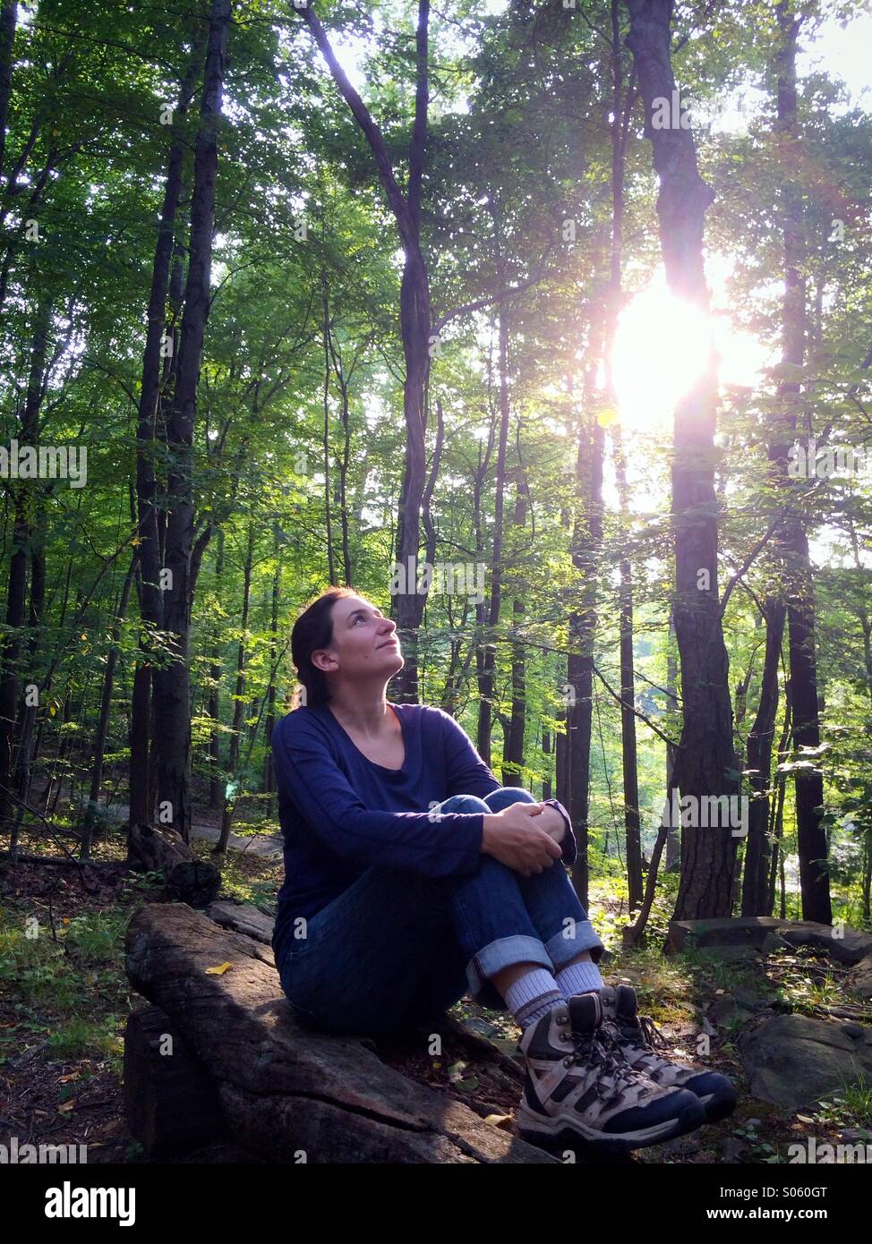A young woman enjoying the tree canopy on a summer nature walk through woods in New Jersey, USA. - Smartphone Captured Stock Image