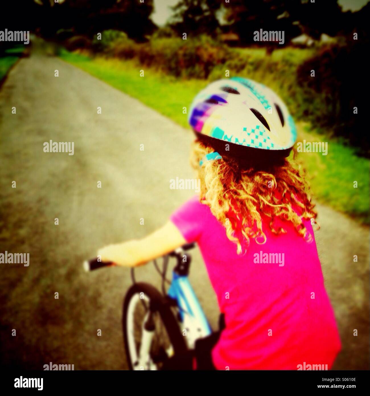 Girl riding bike down country lane Stock Photo Alamy