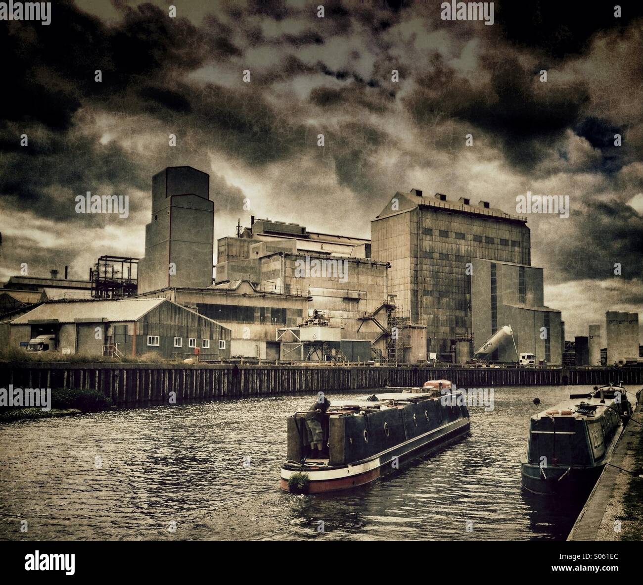 Narrow boats in front of industrial scene on River Weaver - Smartphone Captured Stock Image