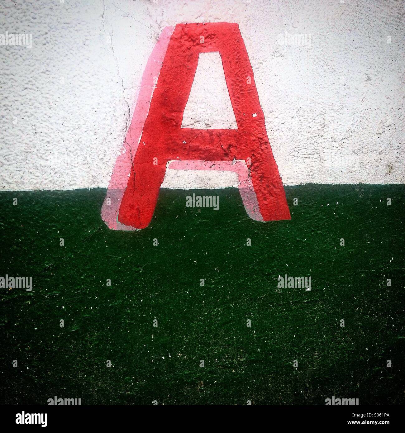 A red letter 'A' decorates a wall painted in green and white in the advertising of a shop in Colonia Roma, Mexico City, Mexico - Smartphone Captured Stock Image