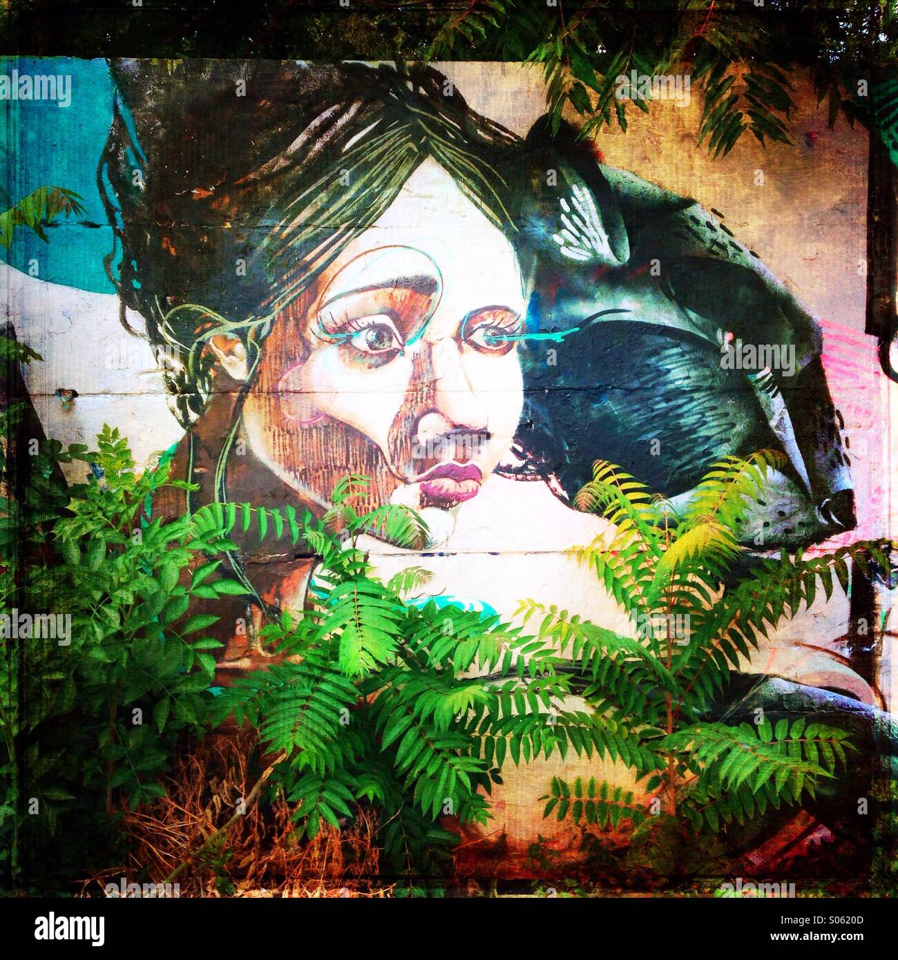 Artistic street art graffiti painted on Berlin Wall - Smartphone Captured Stock Image