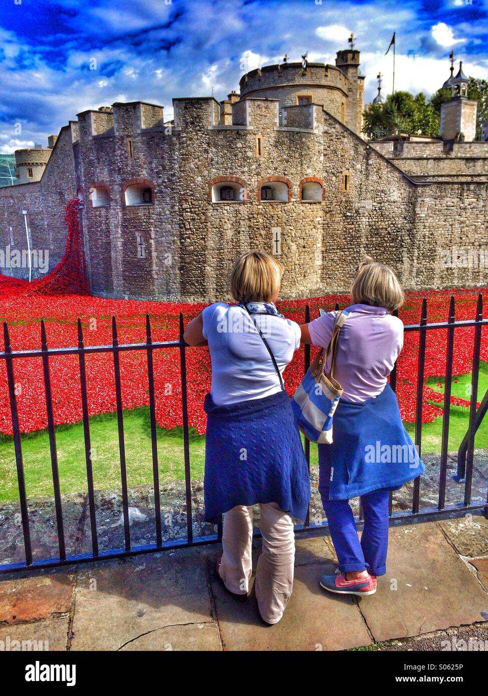 Couple looking at red poppies at Tower of London Stock Photo