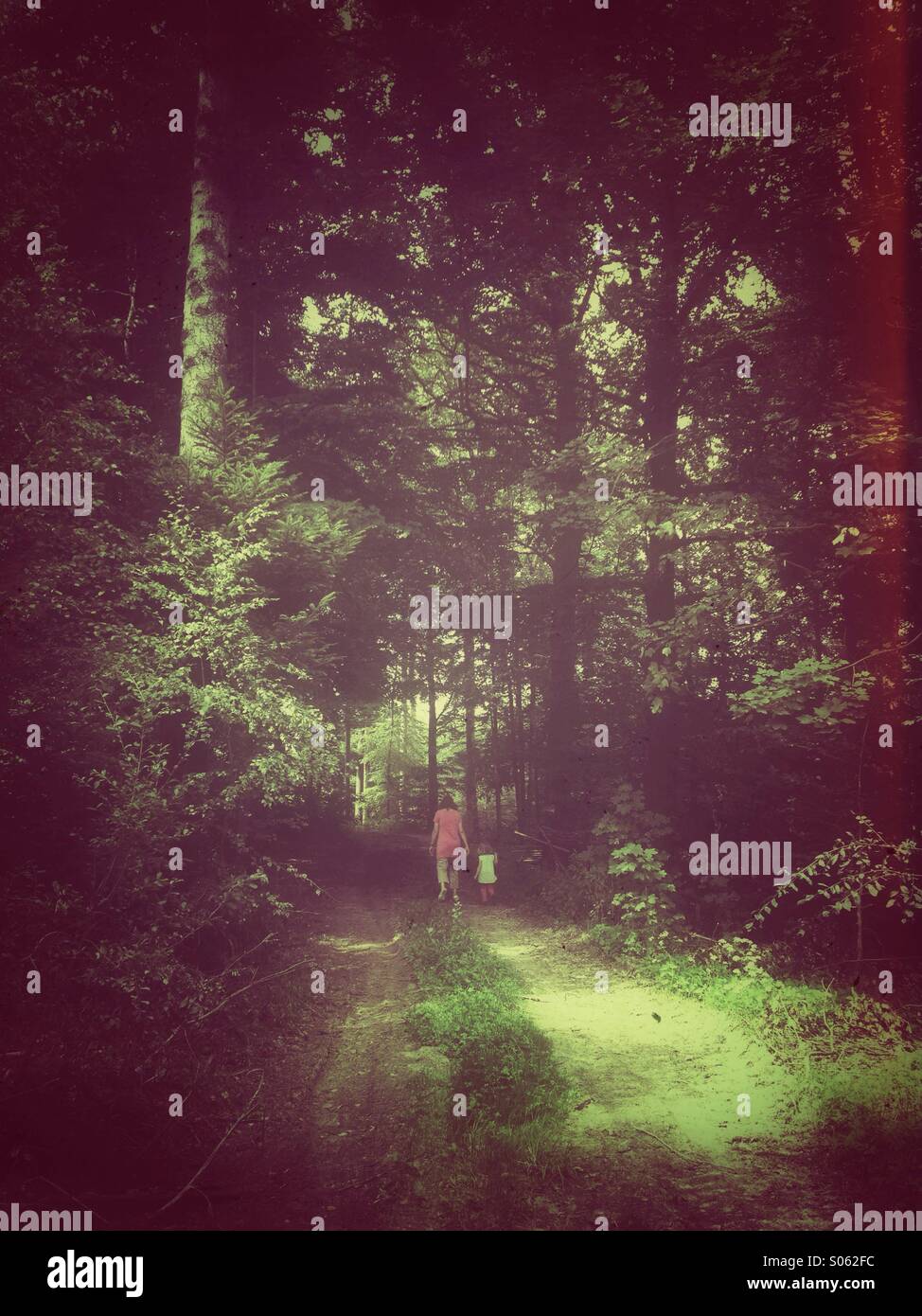 Woman and Child in dark forest. Retro postprocessing. - Smartphone Captured Stock Image