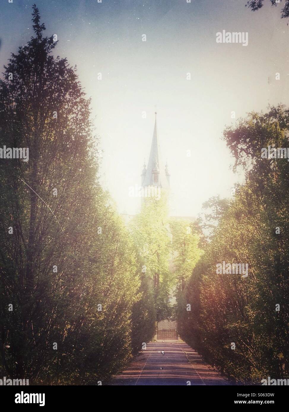 Alley to church.Retro style postprocessing. - Smartphone Captured Stock Image