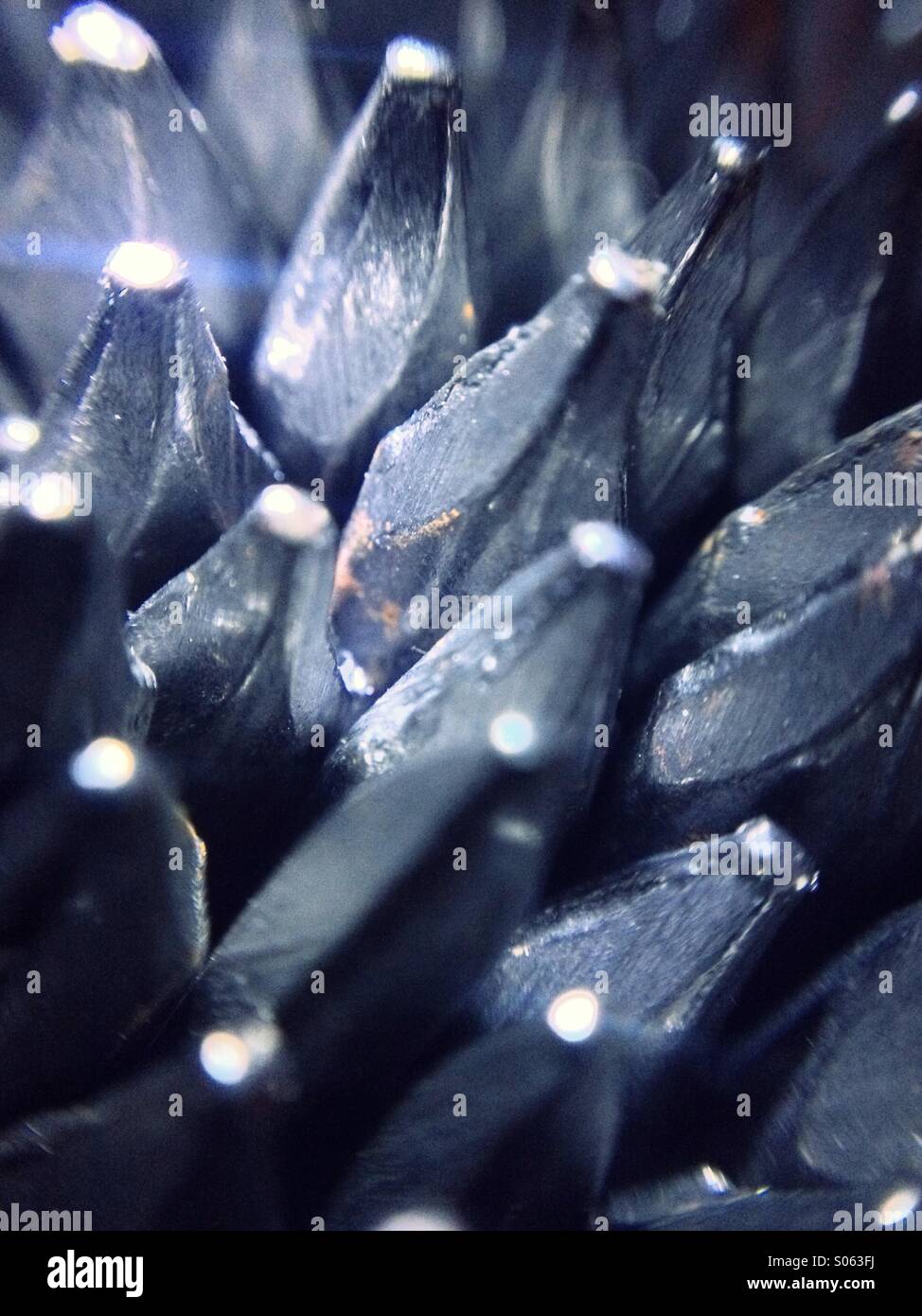 A collection  of nails lit by a torch - Smartphone Captured Stock Image
