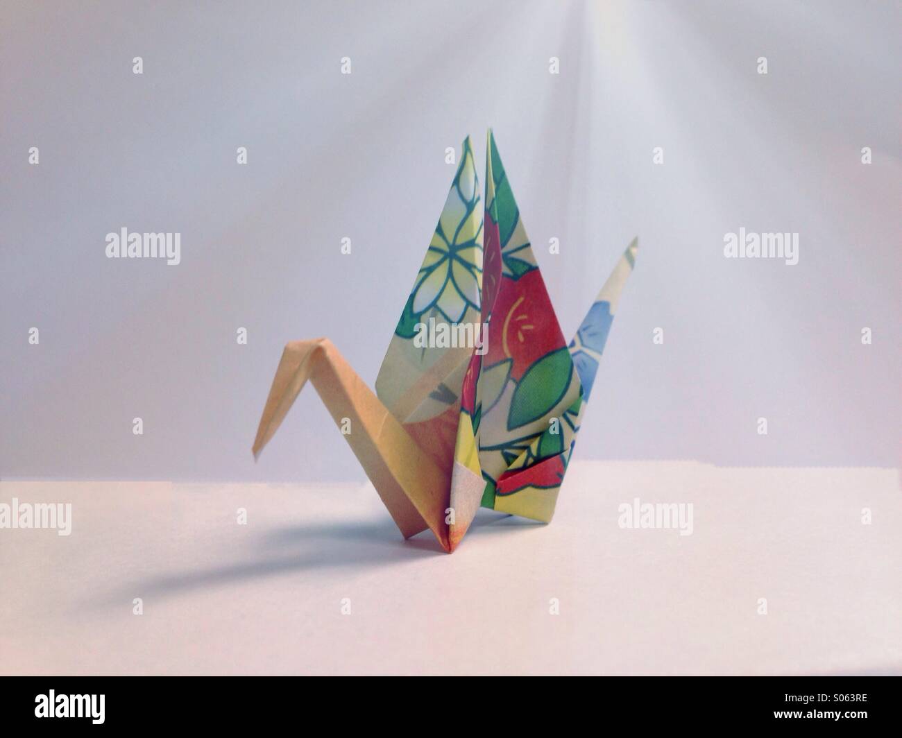 Origami swan with light beam. - Smartphone Captured Stock Image