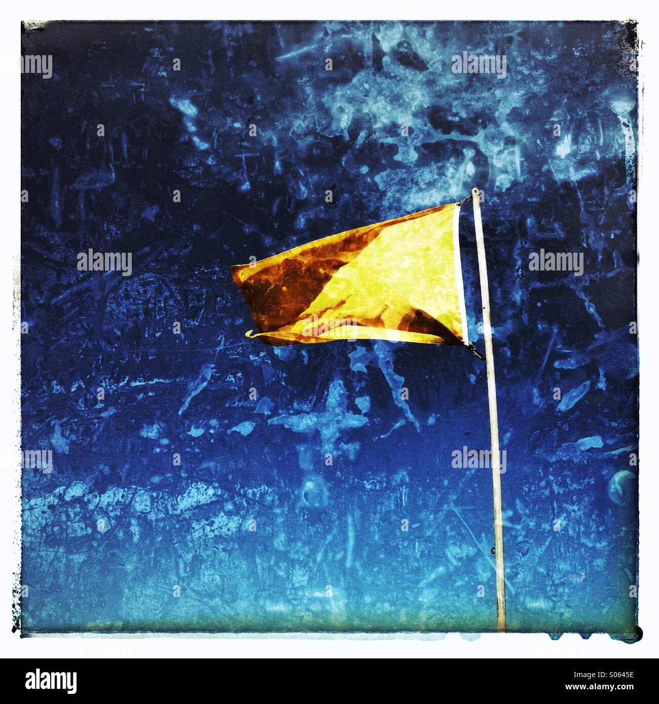 A yellow flag flying on Florida's beaches means there is a medium surf hazard. - Smartphone Captured Stock Image