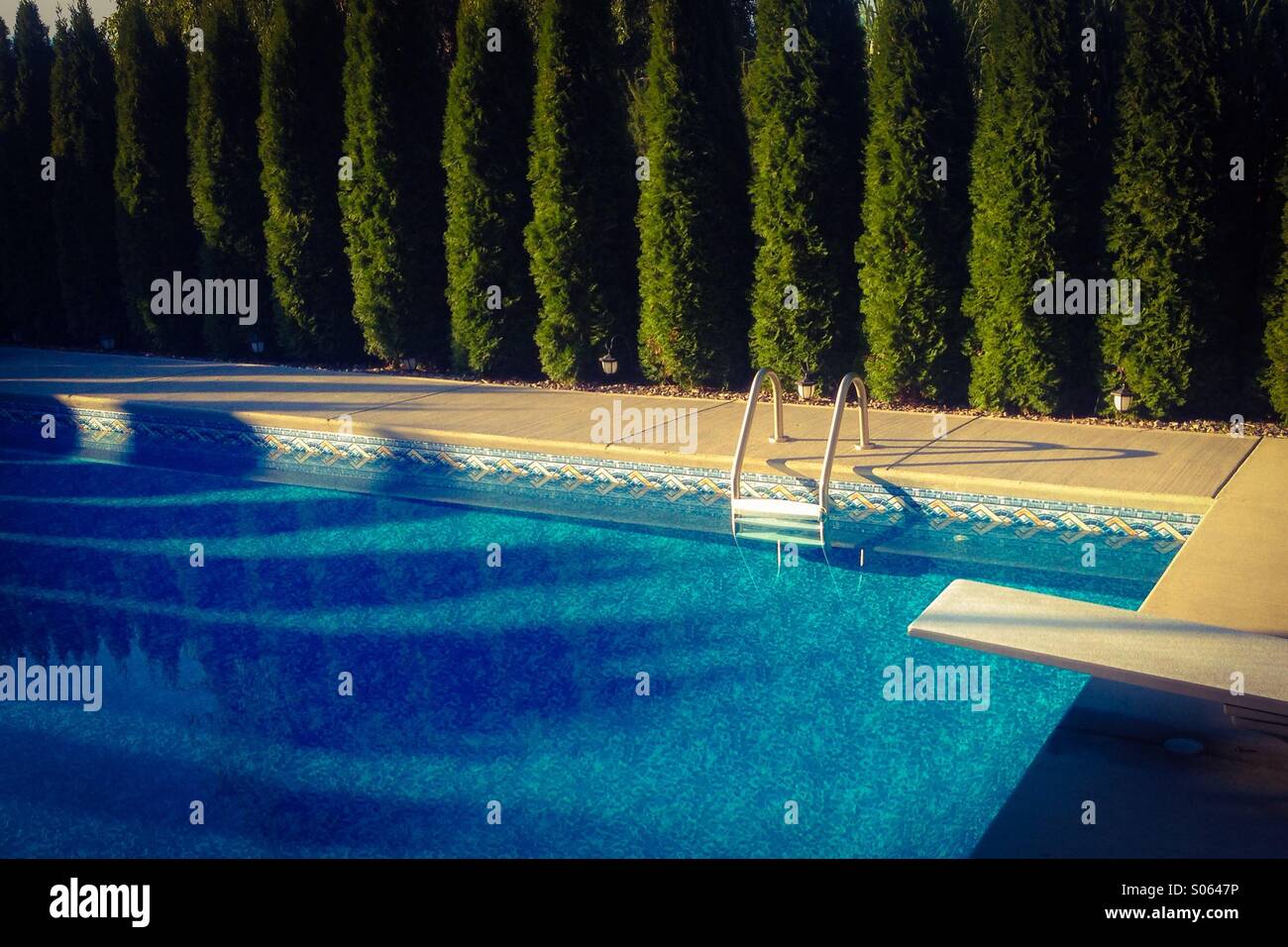 Backyard swimming pool in the early morning summer light. - Smartphone Captured Stock Image