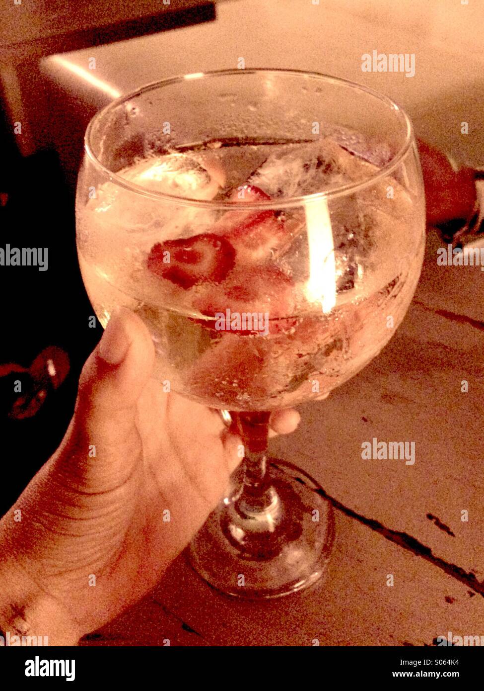 Hand holding gin tonic Stock Photo Alamy