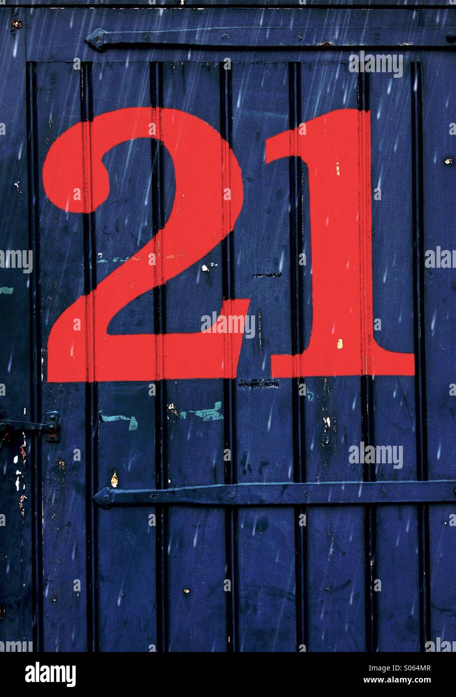 Close up of a door with the number 21 Stock Photo