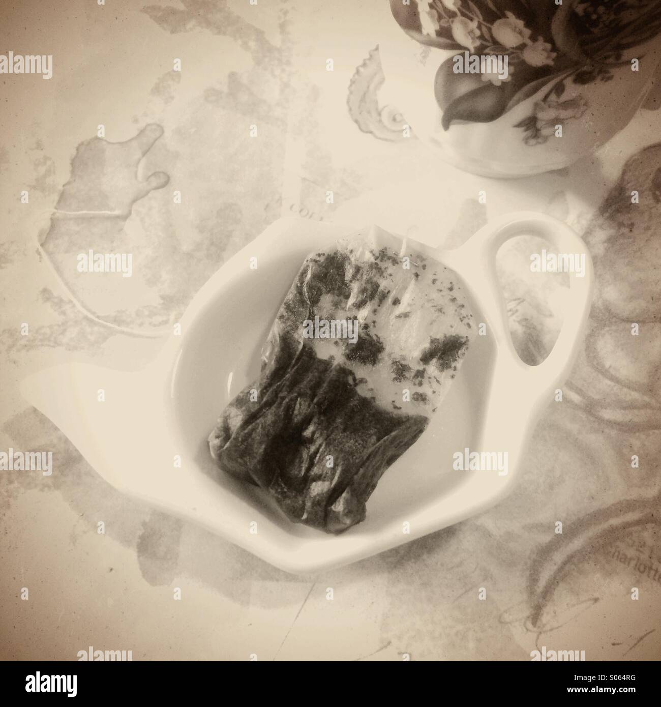 Teabag on teapot shaped plate. - Smartphone Captured Stock Image