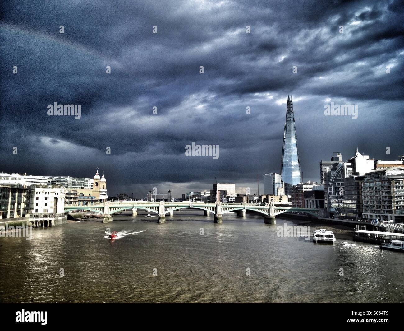 A stormy sky over London looking towards Blackfriars bridge and the Shard skyscraper, with Tower Bridge in the background, England UK - Smartphone Captured Stock Image