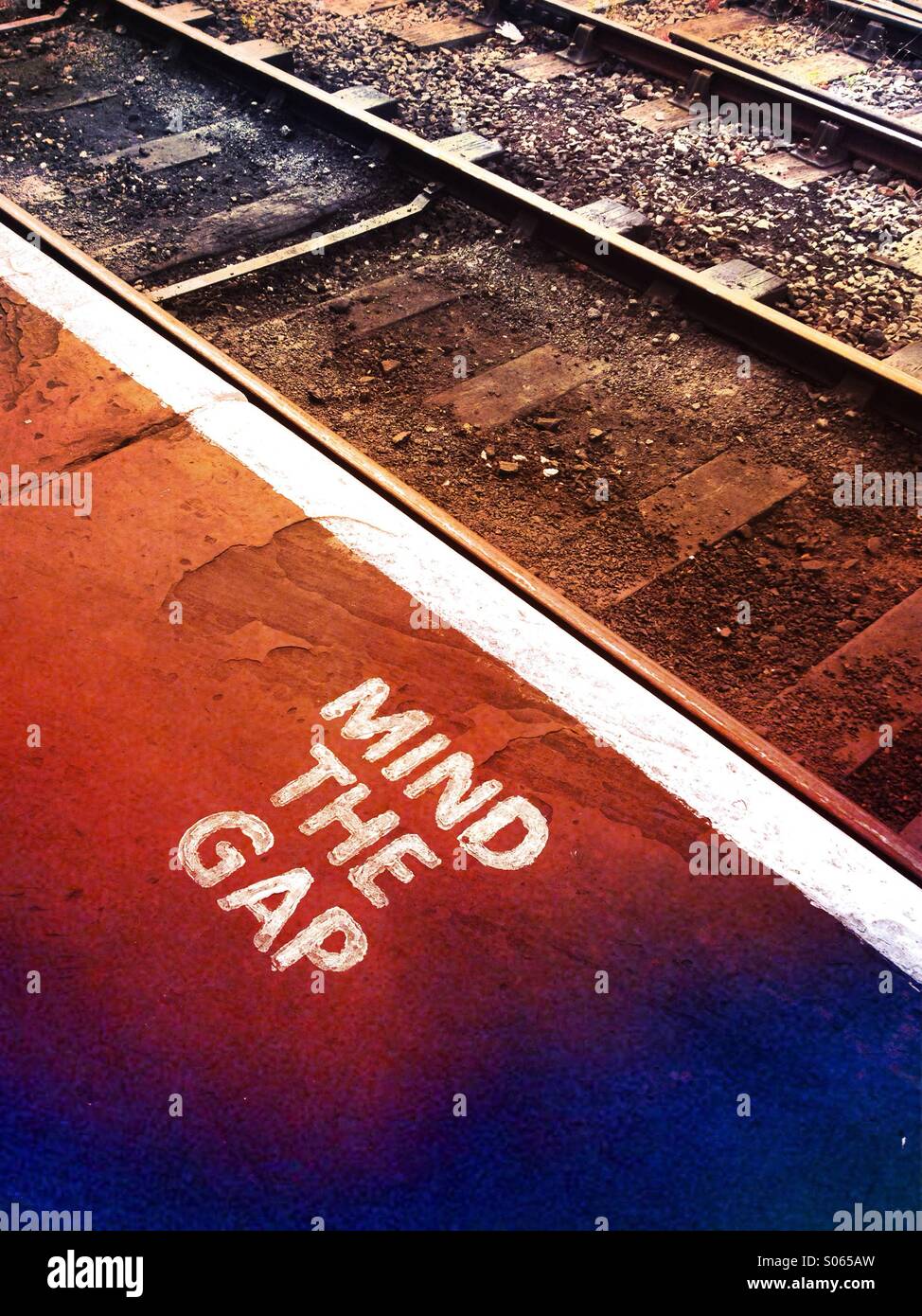 A mind the gap instruction at a railway Stock Photo
