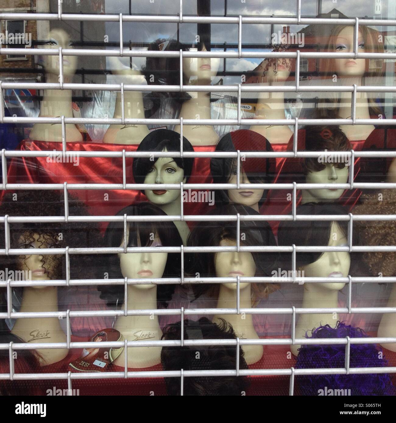 Wigs on a shops window in dalston London - Smartphone Captured Stock Image