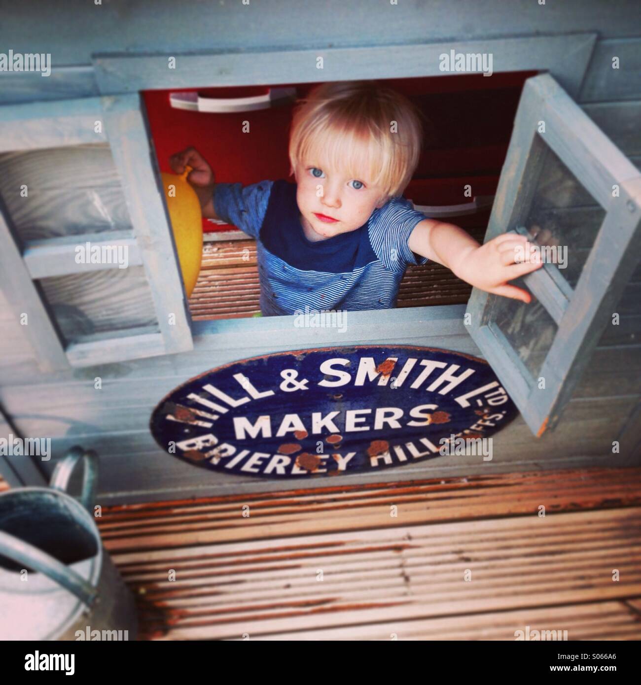 Boy in a playhouse Stock Photo Alamy