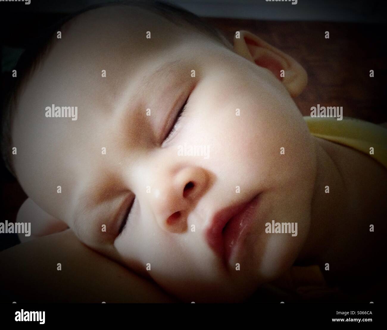 Baby with high fever resting on daddy Stock Photo