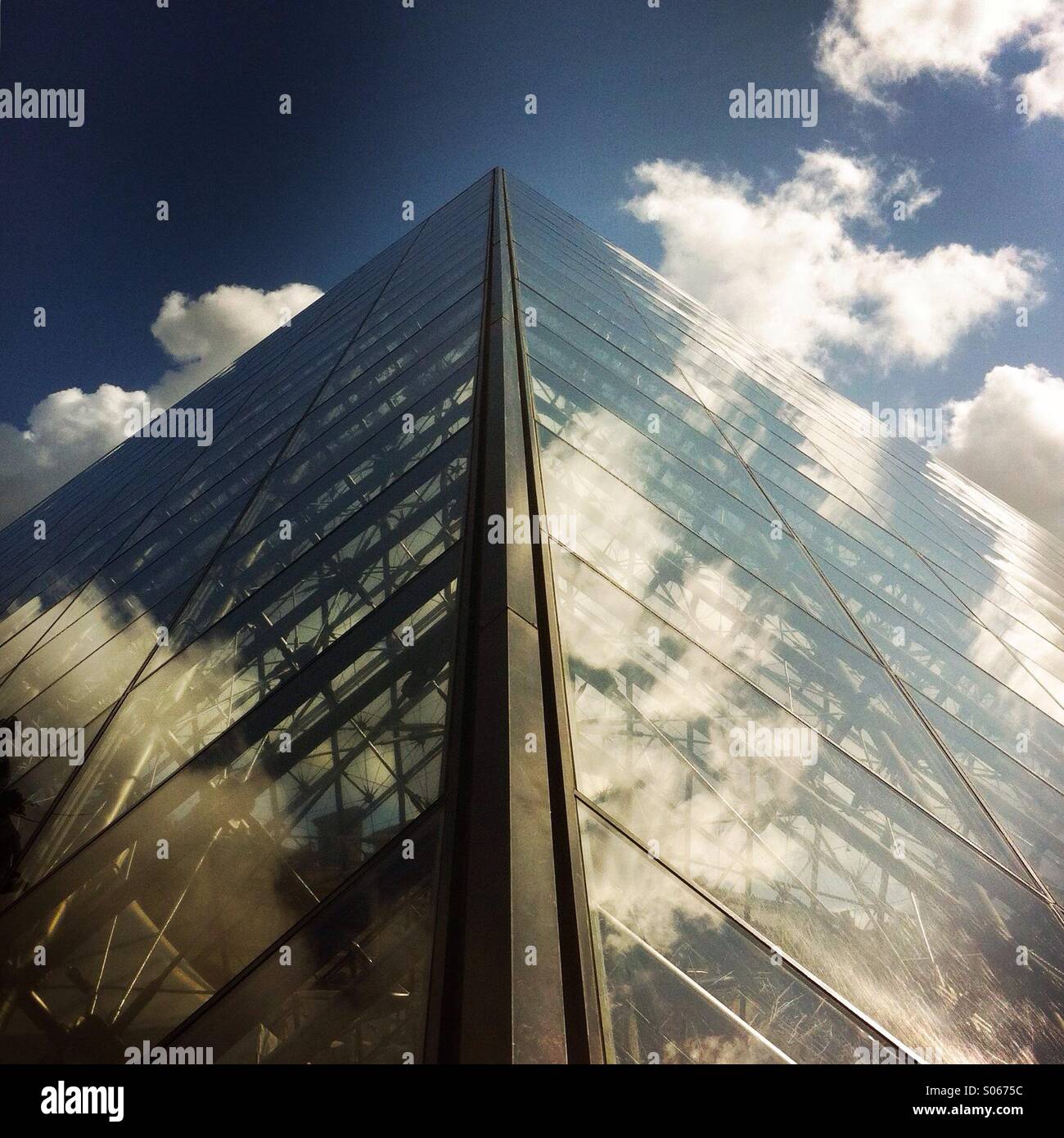 A view of the pyramid structure outside the Louvre museum. Paris, France Europe. - Smartphone Captured Stock Image