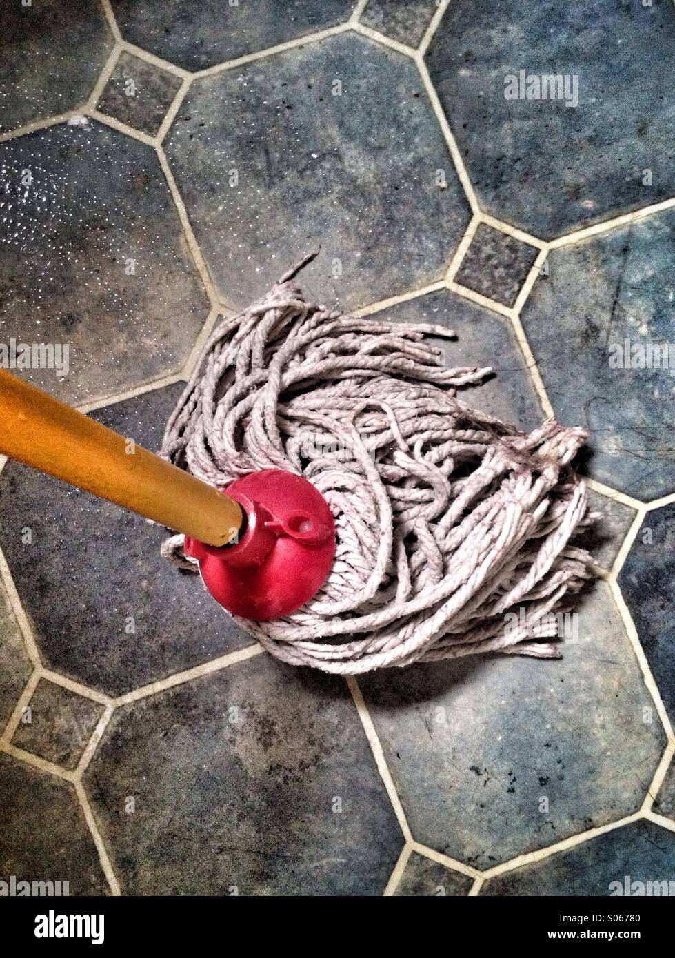 Mopping a filthy floor Stock Photo